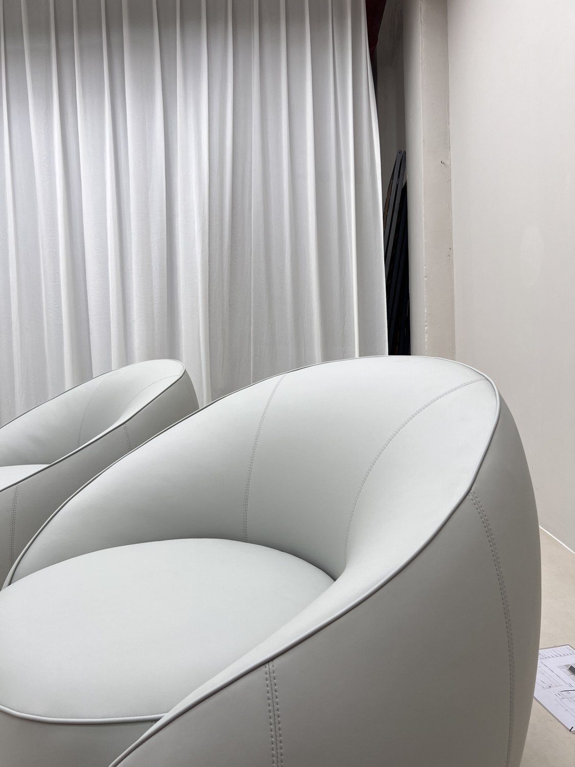 White rounded bouclé lounge chair