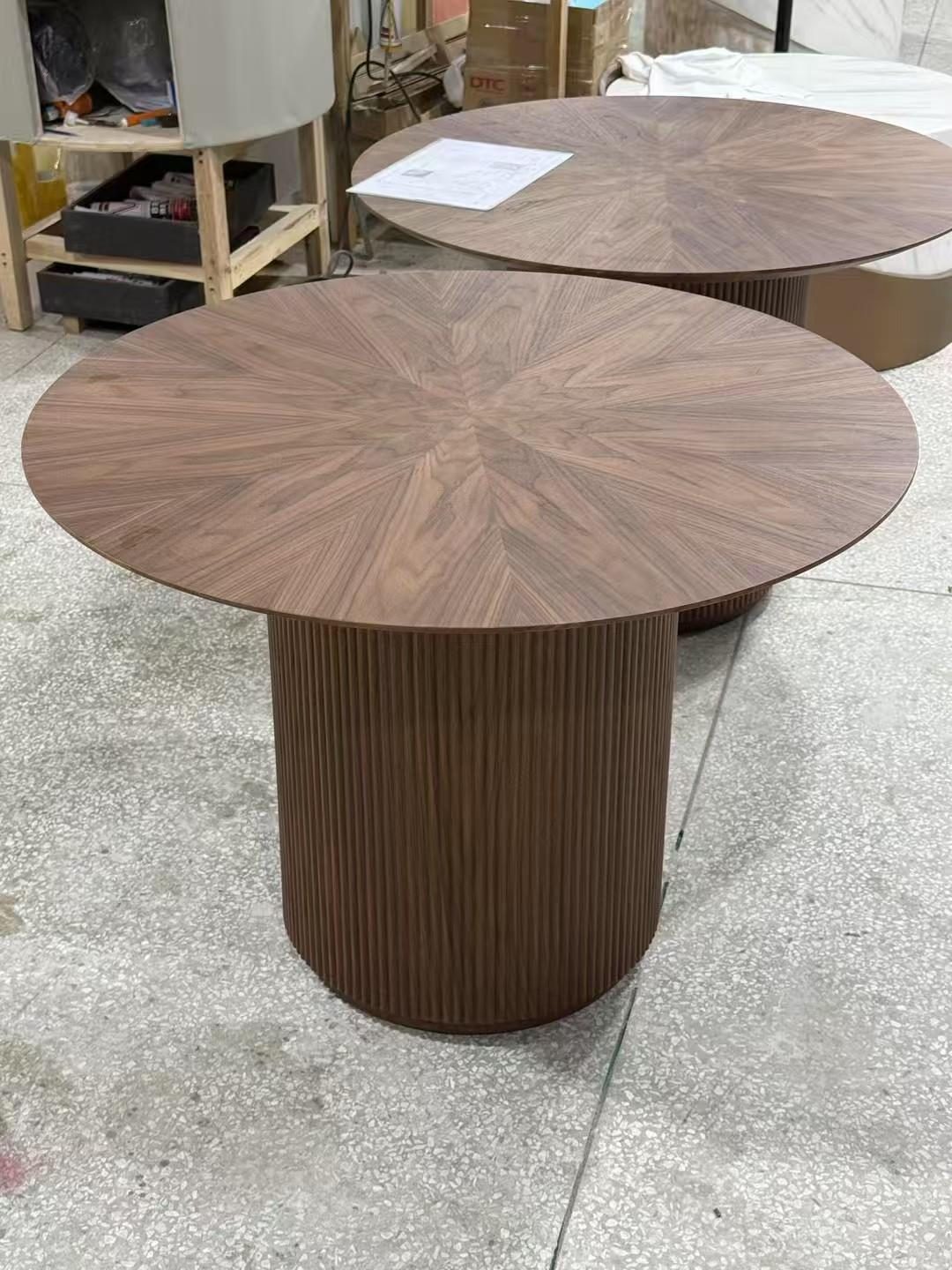 Round pedestal table in dark timber