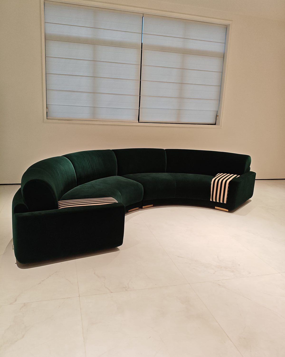 Green curved sofa in the showroom