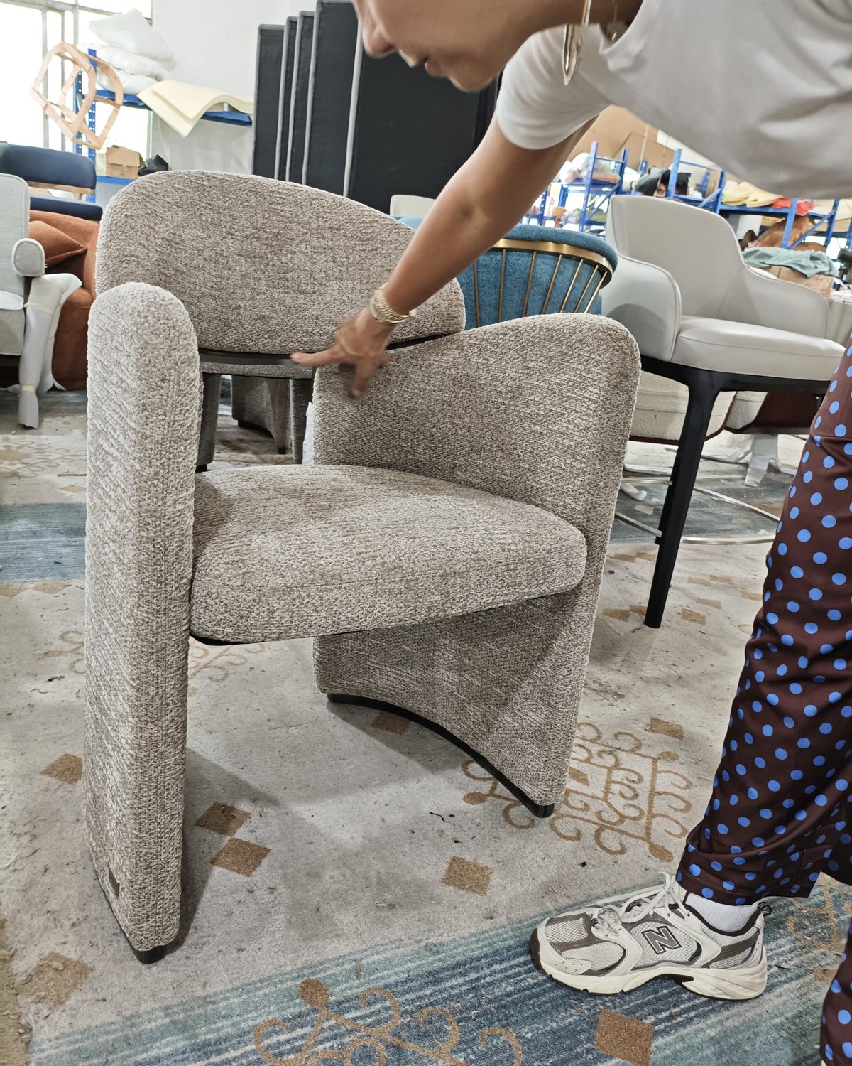 Client reviewing armchair fabric with our team